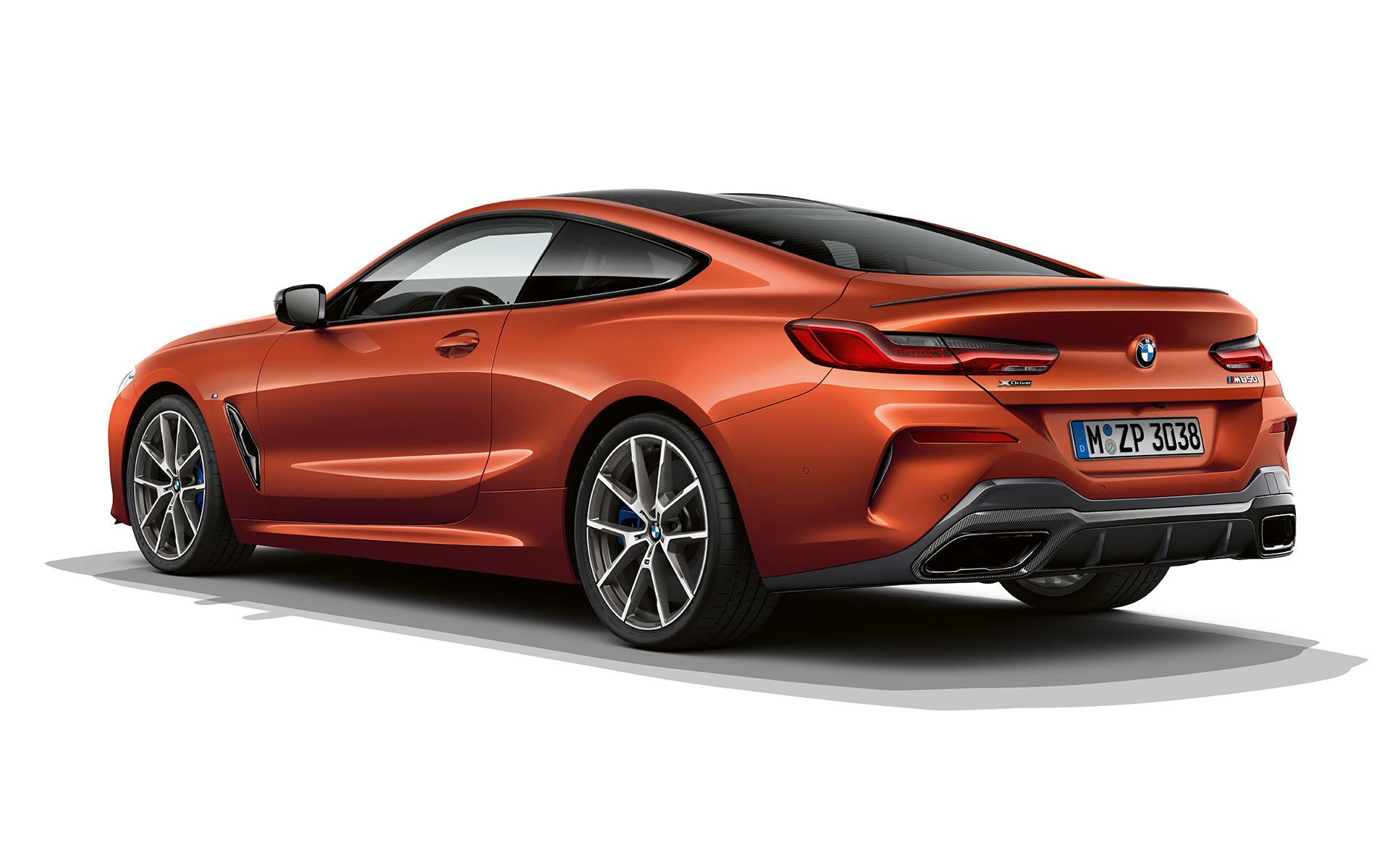 a still shot of the bmw 8 series coupé in sunset orange