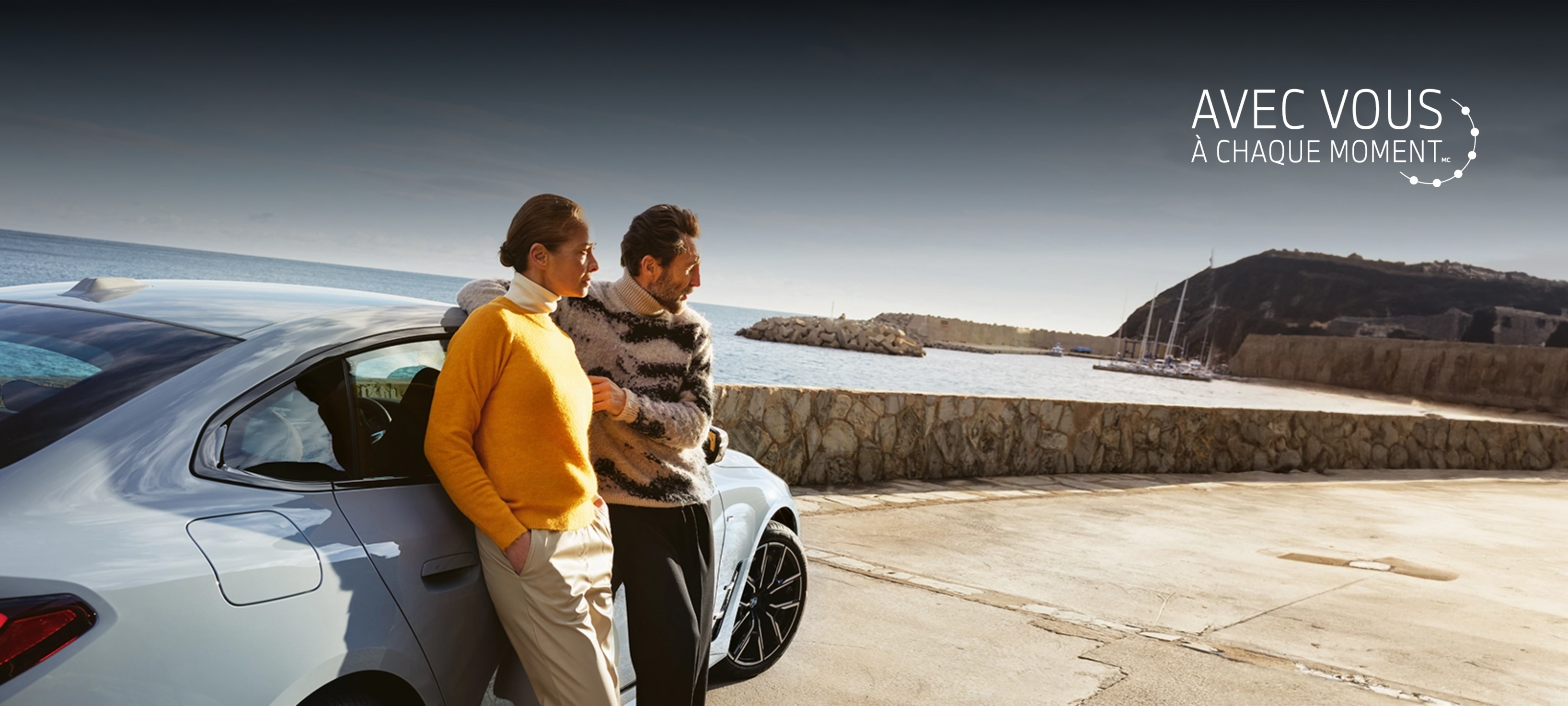 man and woman talking behind BMW